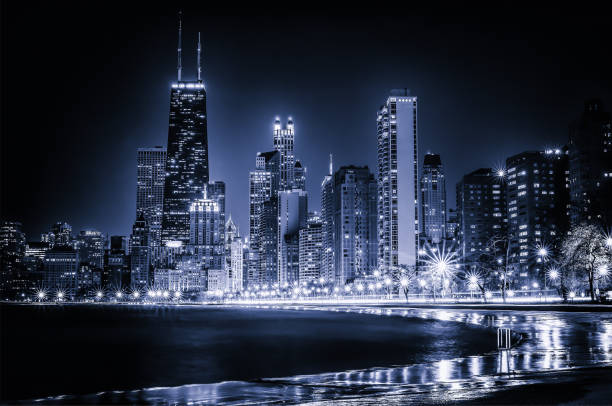 Glowing Chicago Skyline Blue tinted time lapse view along Chicago's curving lakeshore. Surreal view. chicago illinois photos stock pictures, royalty-free photos & images