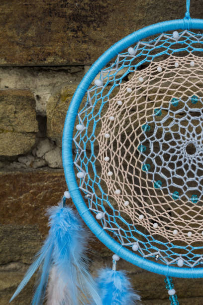 istock Handmade dream catcher with feathers threads and beads rope hanging 940446950