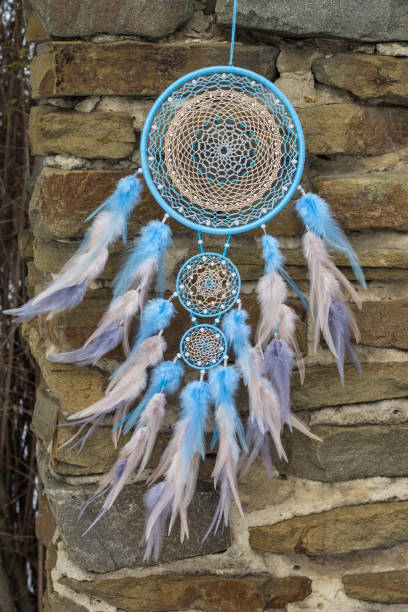 istock Handmade dream catcher with feathers threads and beads rope hanging 940446958