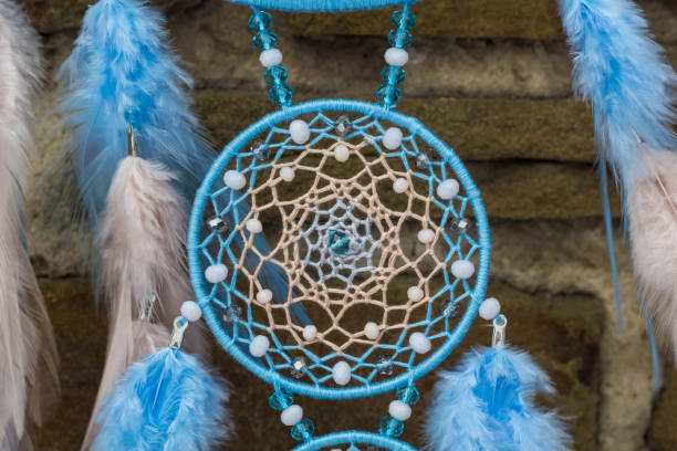 istock Handmade dream catcher with feathers threads and beads rope hanging 940446960
