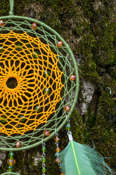 istock Handmade dream catcher with feathers threads and beads rope hanging 940447244
