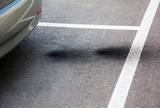 Vehicle Exhaust Pollution Marks. Vehicle bad exhaust marks on the ground showing air pollution,environment destruction, bad combustion, engine problems. gas mark stock pictures, royalty-free photos & images