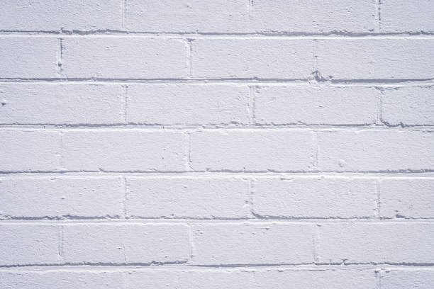 istock Old house sandstone brick wall made with white red orange stone, small gabs between stone pieces vintage texture block background 940450516