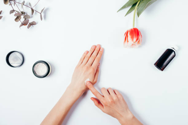 istock Woman's hands apply cream on skin to test it. Top view. 940450714