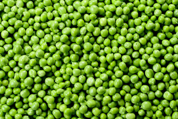 istock Green Peas. Green background. Peas background. Top view. 940451202