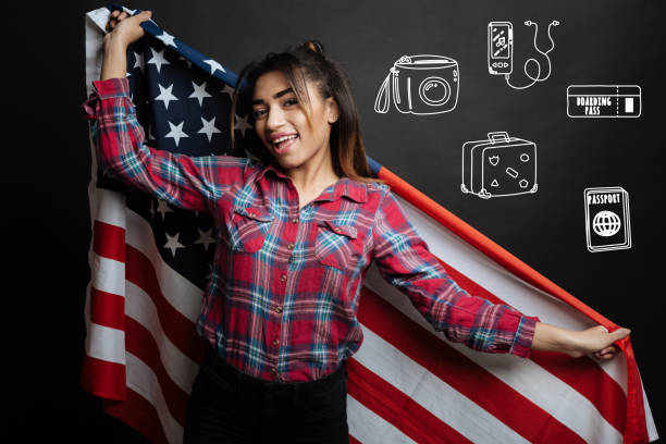 Happy touristic holding the USA flag while visiting this country