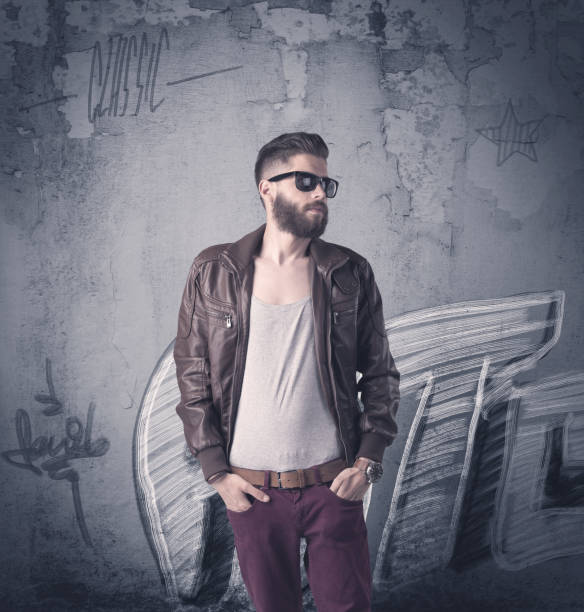 istock Fashion model standing at graffiti wall 940454052