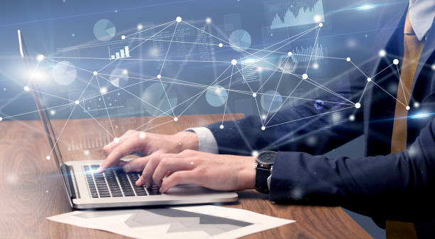 istock Hand typing on laptop with linked report and charts around 940458208