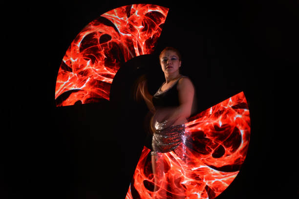 istock Led poi. Laser show performance, dancer in led suits with LED lamp 940458318