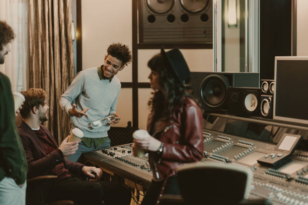 istock young music band drinking coffee to go at recording studio 940461942
