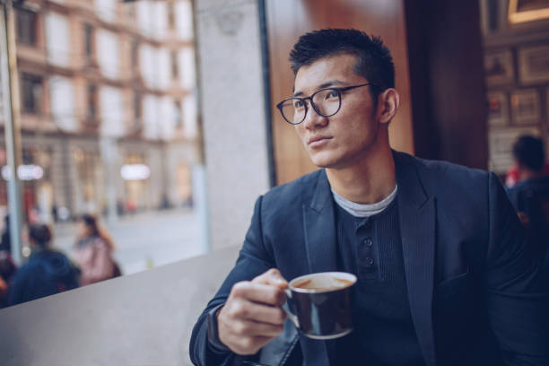 istock Hipster man holding cup of coffee 940462266