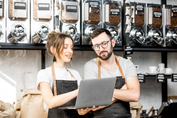 istock Coffee store owners working with laptop indoors 940463166