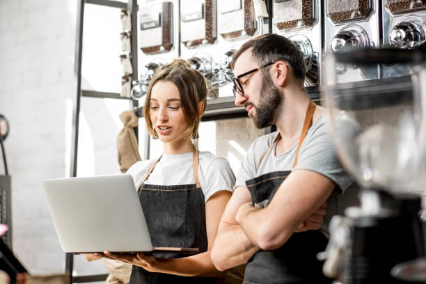 istock Coffee store owners working with laptop indoors 940463208