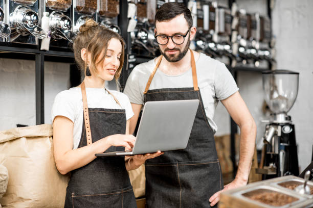 istock Coffee store owners working with laptop indoors 940463272