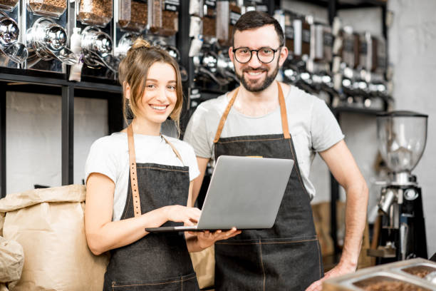 istock Coffee store owners working with laptop indoors 940463332
