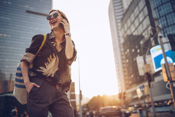 istock Woman using mobile phone outdoors 940466372