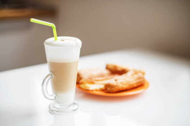 a cup of latte on the table. morning coffee with cakes. breakfast