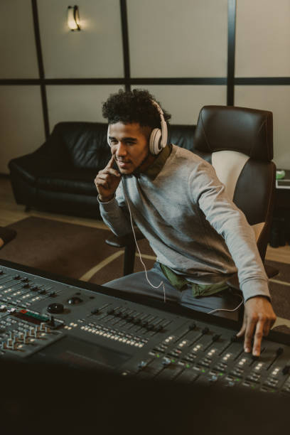 istock smiling young sound producer sitting at studio 940466420