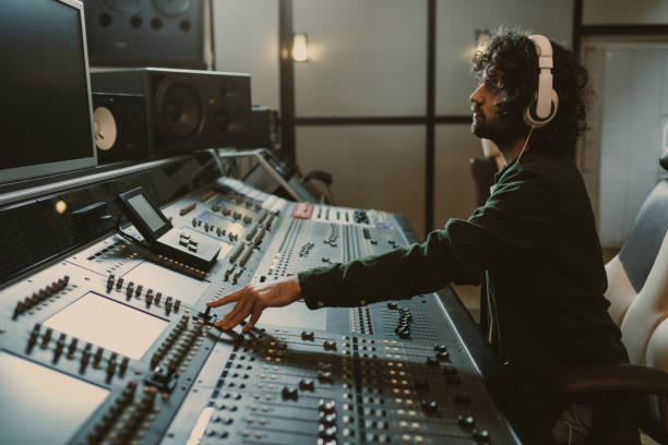 istock side view of concentrated sound producer working at studio 940466496