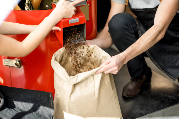 istock Pouring roasted coffee beans from the machine 940469026