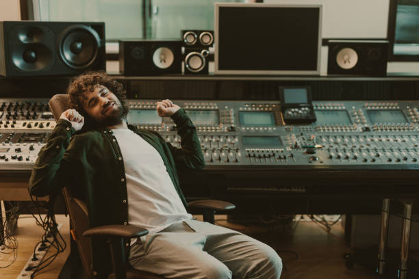 istock happy tired sound producer stretching in studio 940469202