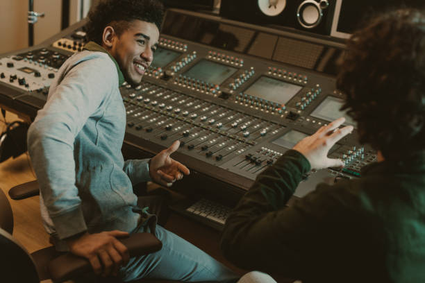 istock happy sound producers talking at recording studio 940469250