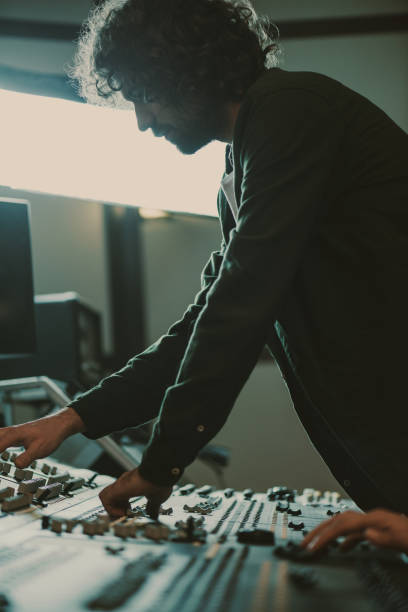 istock handsome young sound producer working with recording equipment 940469452