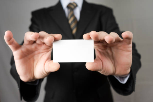 istock Businessman holding a business card. Mock up. Copy space. 940478982