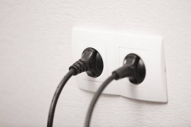 istock Close-up view of electric outlets with power cables 940487758