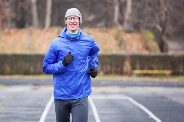 istock Cropped shot of a happy young man running. 940492190