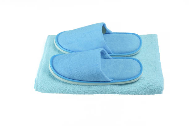 istock Blue washable slippers with rubber outsole on blue towel isolated on white background 940502320