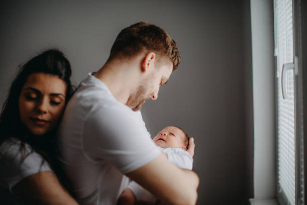istock Happy parents playing with their newborn daughter 940502808