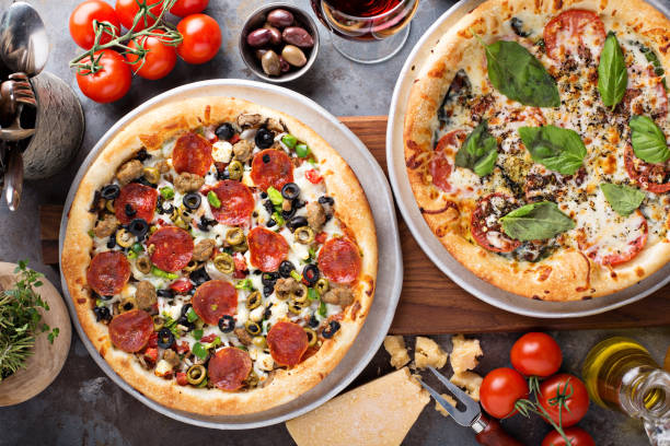 istock Margherita and pepperoni pizza with basil 940502872