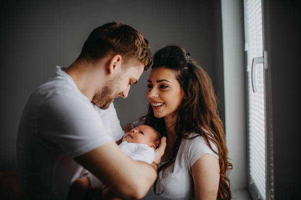 istock Happy parents playing with their newborn daughter 940502960