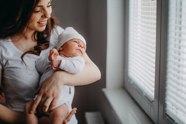 istock Mother holding her baby girl 940505016