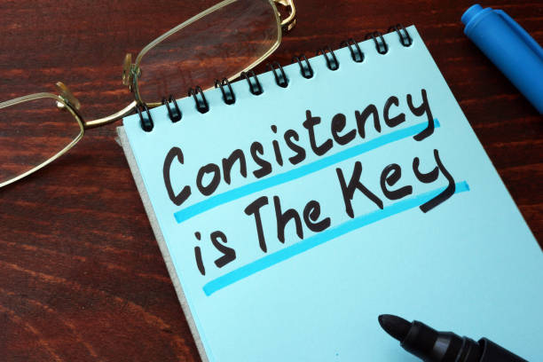 istock Consistency is The Key written on a notepad with marker. 940508548