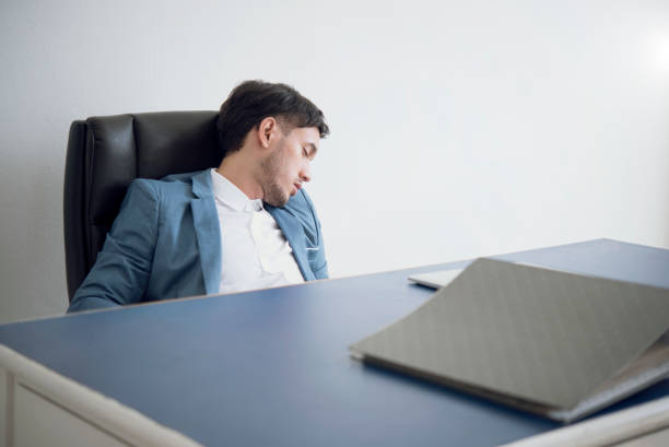 istock Businessman tired overworked sleeping on office desk. 940508756