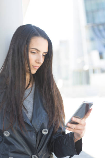 istock City girl on with smart phone 940509126