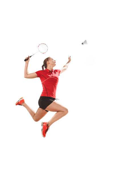 young woman playing badminton over white background - badminton racket isolated white imagens e fotografias de stock