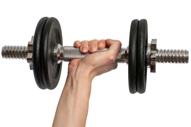 istock hand holding black metal Dumbbell isolated on white background 940512010