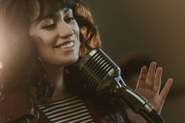 istock attractive young female singer performing song and smiling 940515920