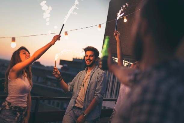 istock Group of friends at a rooftop party 940519238