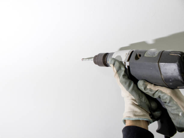 rotary hammer in use composition in a white background - trepan imagens e fotografias de stock