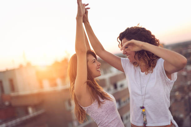 istock Two girls dancing on the building rooftop 940519592