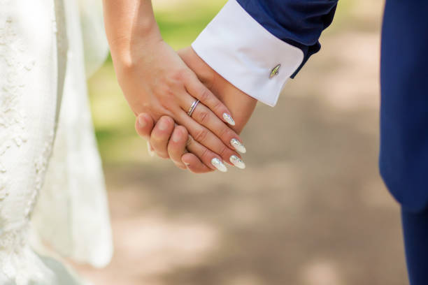 istock wedding theme, man and woman holding hands with a nice manicure neat 940519816