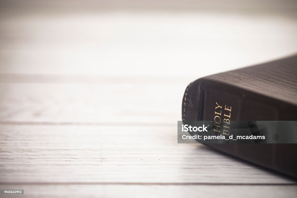 Closed Bible on a Wooden Table Bible Stock Photo