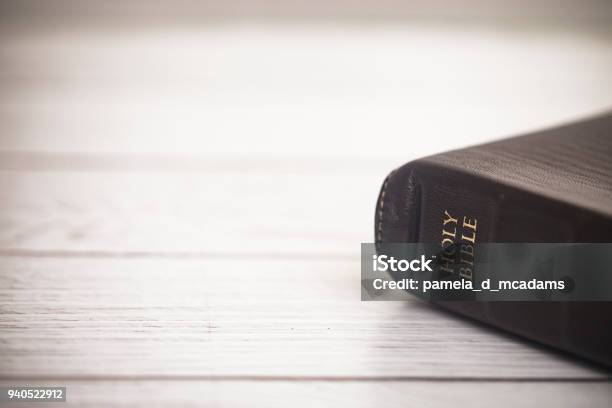 Closed Bible On A Wooden Table Stock Photo - Download Image Now - Bible, Studying, Closed