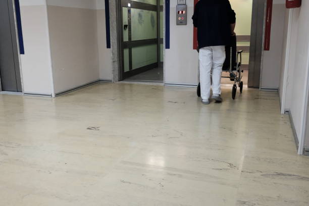 istock nurse with patient in wheelchair in elevator 940523398