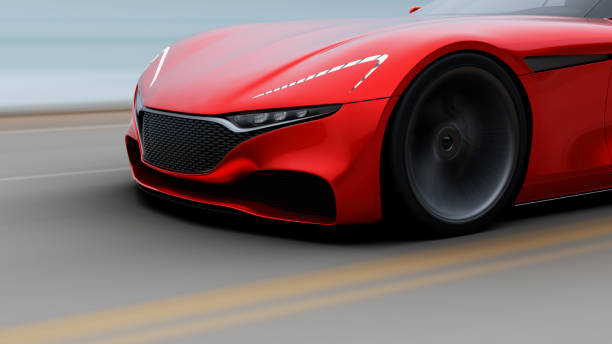 istock red car driving on a road by sea 940523488
