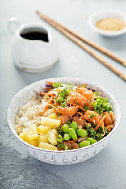 istock Poke bowl with raw salmon, rice and vegetables 940524686